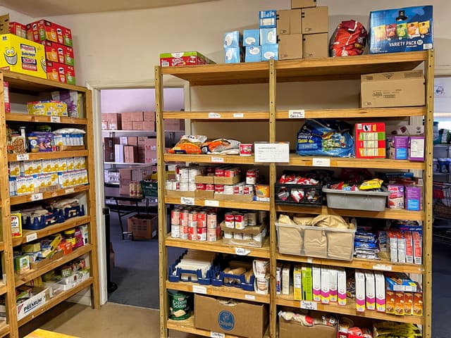 Inside of the pantry stocked with food.